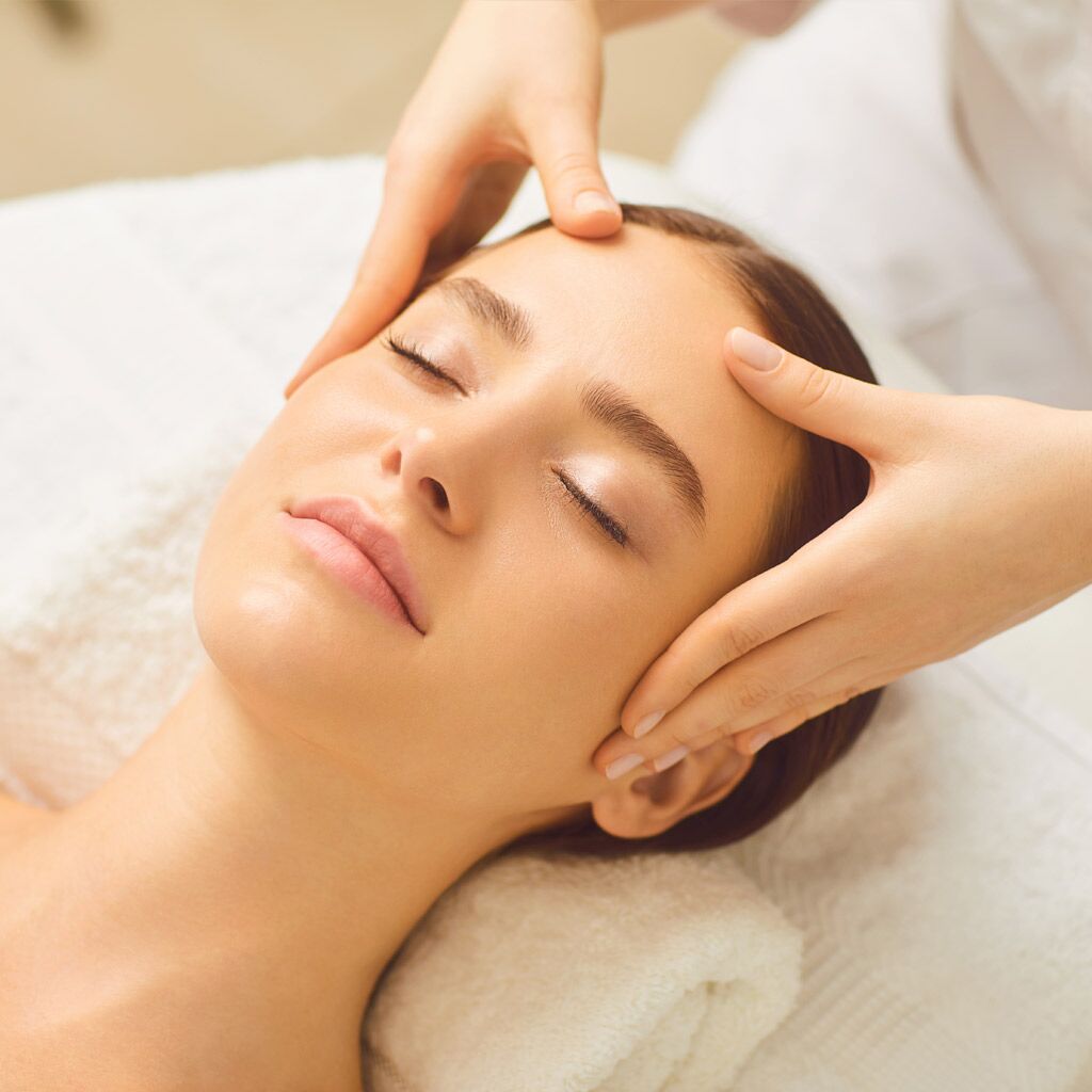 Beautiful girl has a facial massage in a beauty clinic.